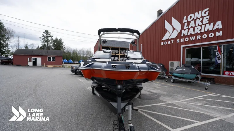 Slide: The Image of 2019 Malibu MXZ boat at Long Lake Marina showroom, parked on a trailer. - 3