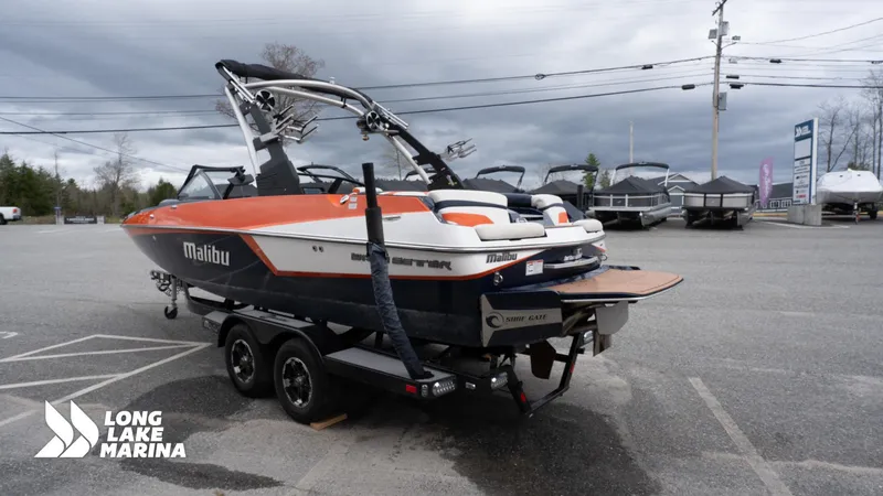 Slide: The Image of 2019 Malibu MXZ boat on trailer at Long Lake Marina parking lot. - 6