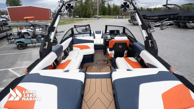 Slide: The Image of 2019 Malibu MXZ boat interior with orange and white seating at Long Lake Marina. - 9