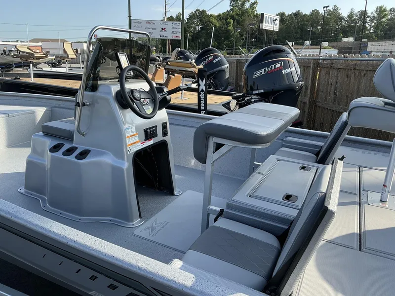 Slide: The Image of 2025 Xpress Xplorer Series XP20CC boat interior with steering console and seating. - 7