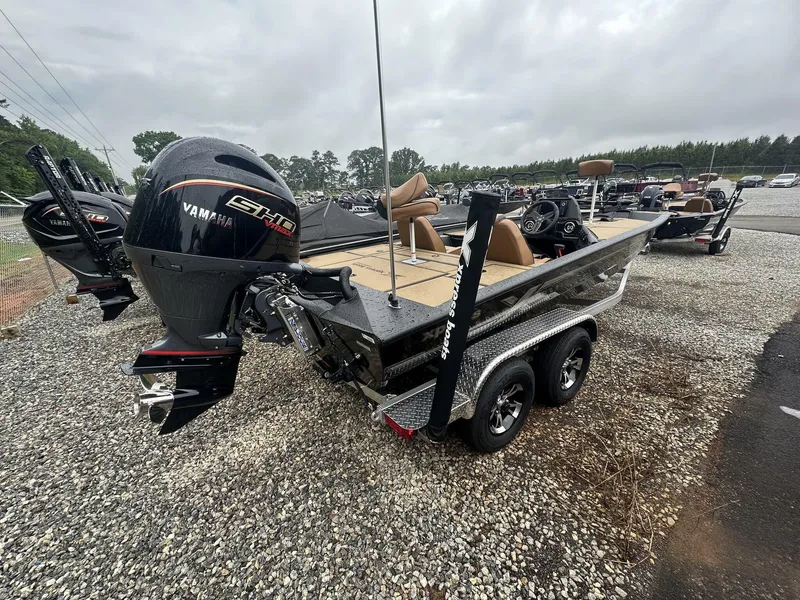 Slide: The Image of 2025 Xpress Hyper-Lift Bass Series boat with Yamaha engine on a trailer. - 4