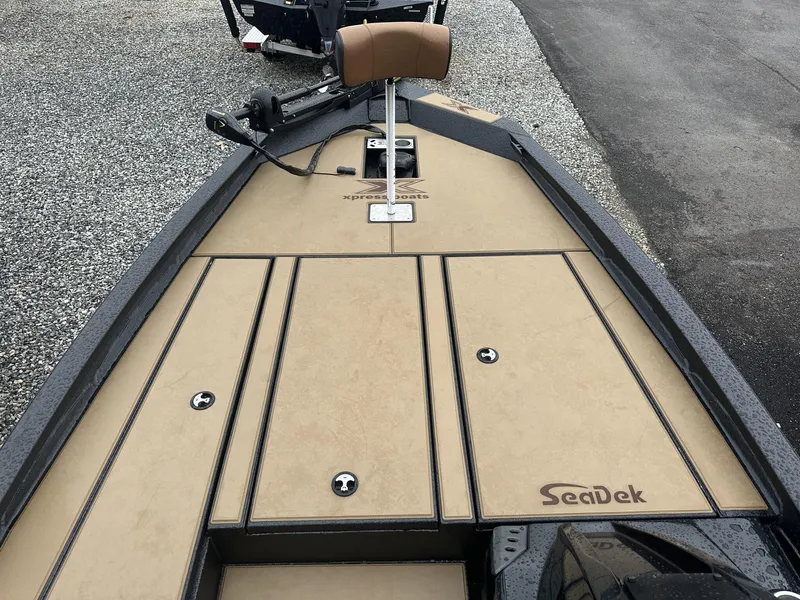 Slide: The Image of 2025 Xpress Hyper-Lift Bass Series boat deck with SeaDek flooring, featuring storage compartments. - 7