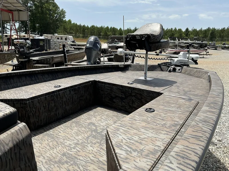 Slide: The Image of 2025 Xpress Hyper-Lift Series H22B boat with camouflage design in a boatyard. - 7