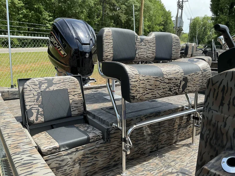 Slide: The Image of 2025 Xpress Hyper-Lift Series H22B boat interior with camo seating and powerful outboard motor. - 9