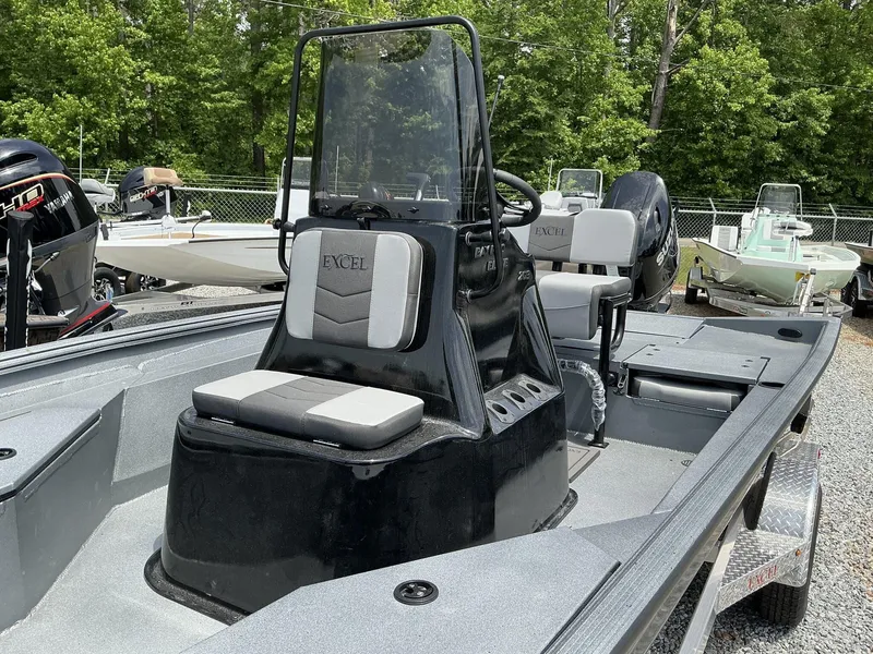 Slide: The Image of 2025 Excel Bay Pro 203 Elite boat with seating, steering console, and outboard motor. - 5
