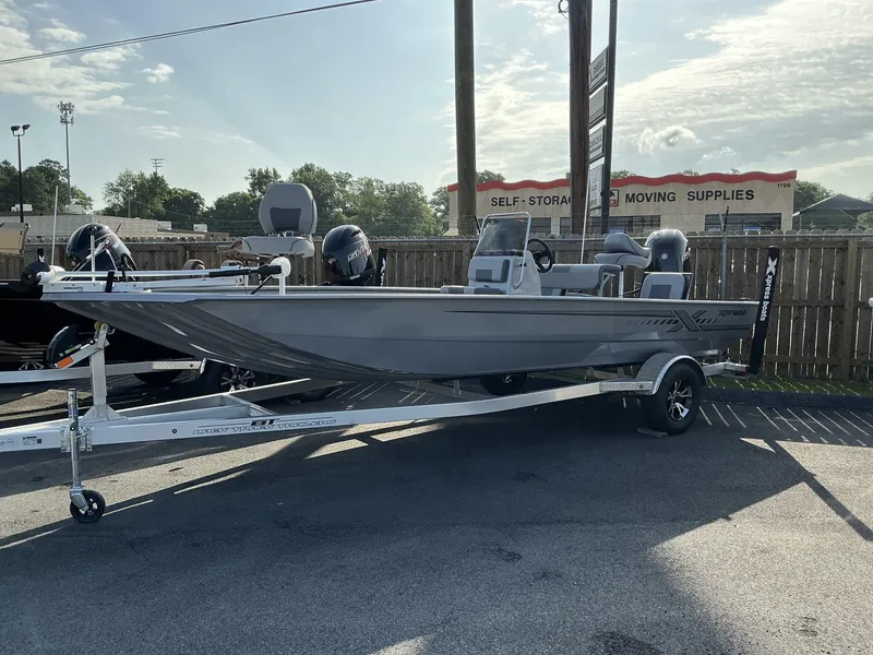 Slide: The Image of 2025 Xpress Xplorer Series XP20CC boat on trailer in parking lot. - 1