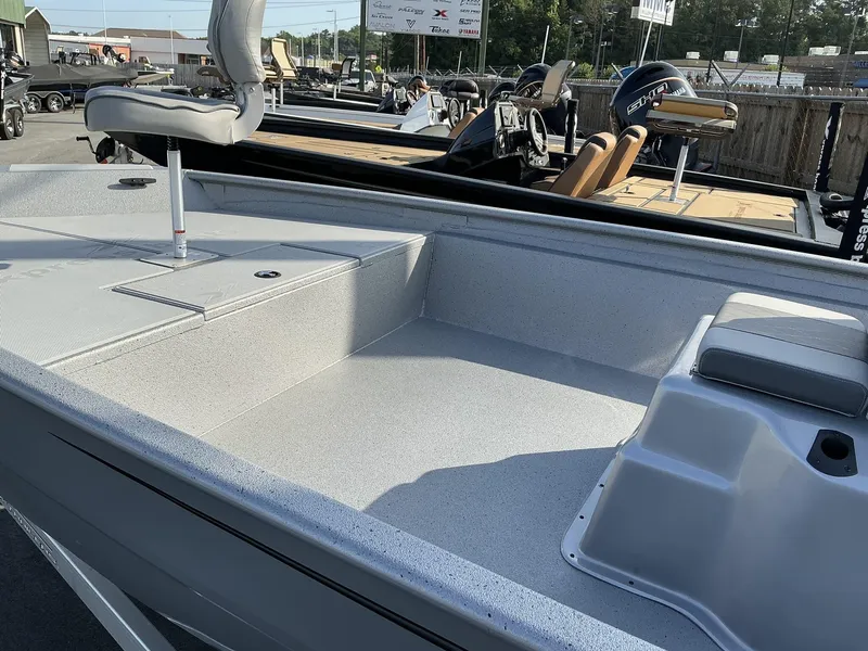 Slide: The Image of 2025 Xpress Xplorer Series XP20CC boat interior with seating and storage compartments. - 2