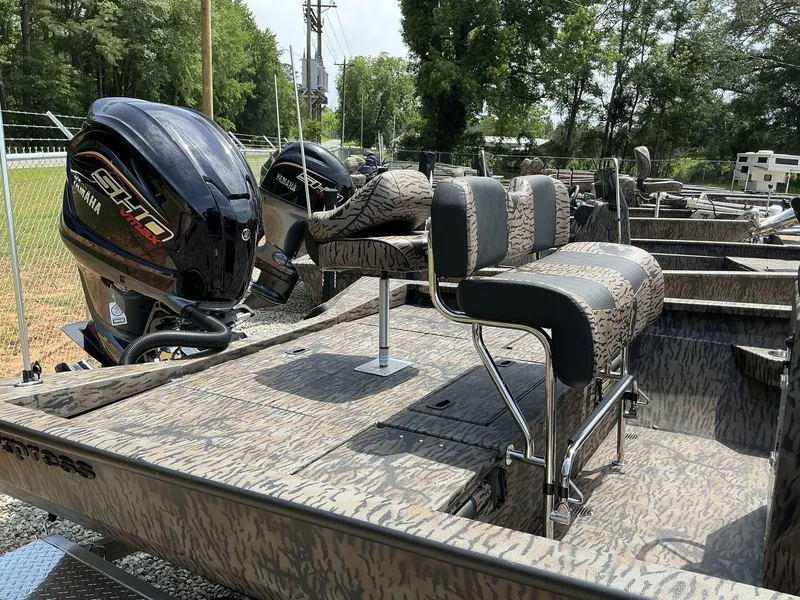 Slide: The Image of 2025 Xpress Hyper-Lift Series H22B boat with Yamaha engines, camo seats, and outdoor setting. - 11