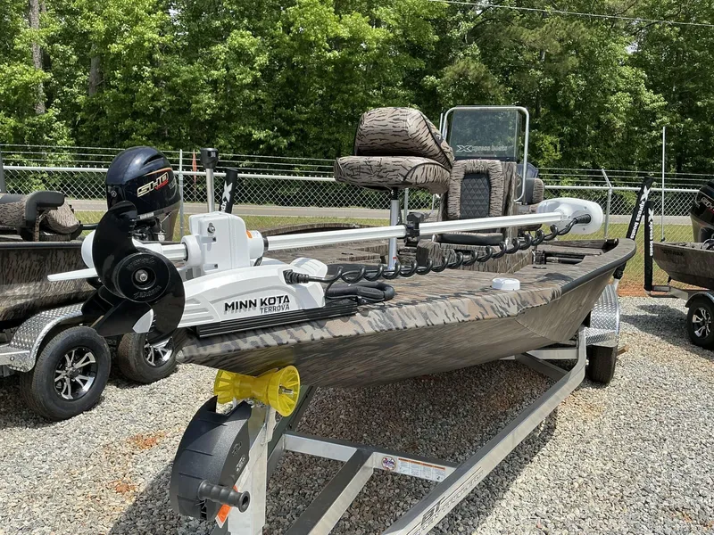 Slide: The Image of 2025 Xpress Hyper-Lift Series H22B boat with Minn Kota Terrova motor, parked on gravel. - 6