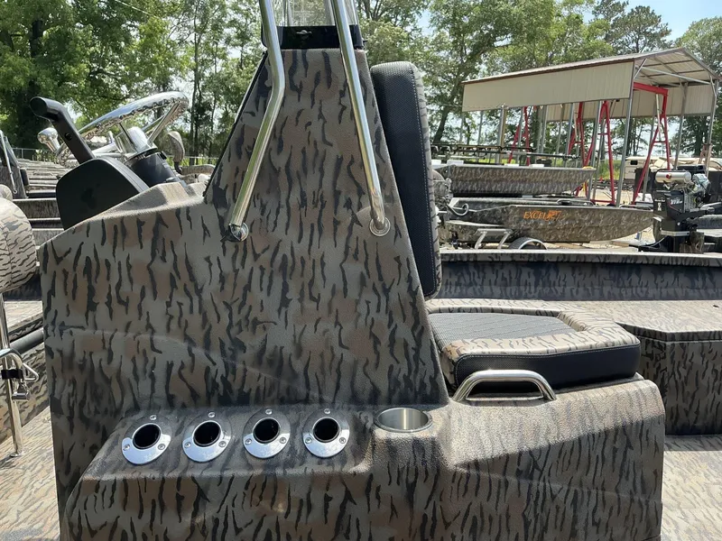 Slide: The Image of 2025 Xpress Hyper-Lift Series H22B boat interior with camouflage design and steering console. - 8