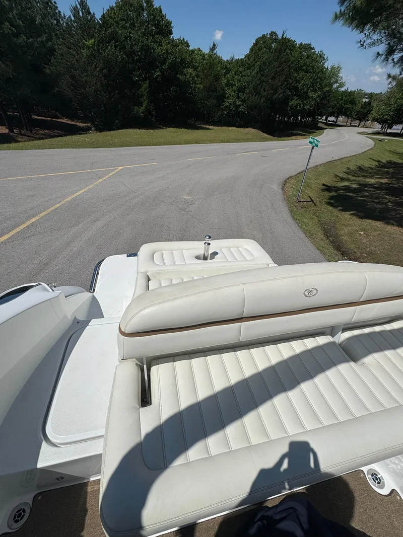Slide: The Image of 2015 Cobalt R3 boat with white seating, parked near a road and trees. - 12
