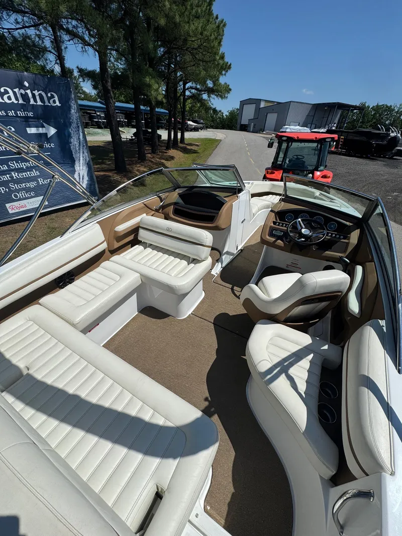 Slide: The Image of Interior of a 2015 Cobalt R3 boat with white seating and dashboard. - 2