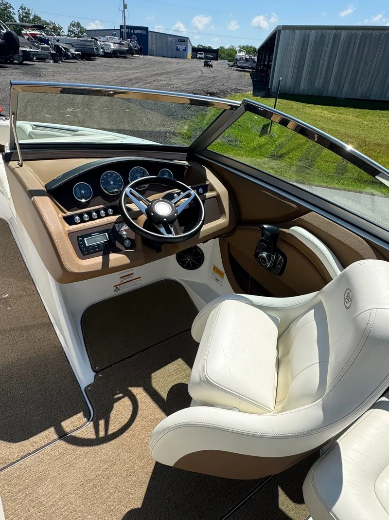 Slide: The Image of 2015 Cobalt R3 boat interior with steering wheel and dashboard, featuring beige and white seating. - 6