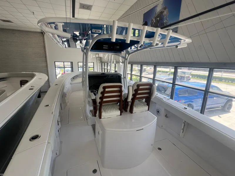 Slide: The Image of 2022 Jupiter 34 FS boat interior with seating and console in showroom. - 10