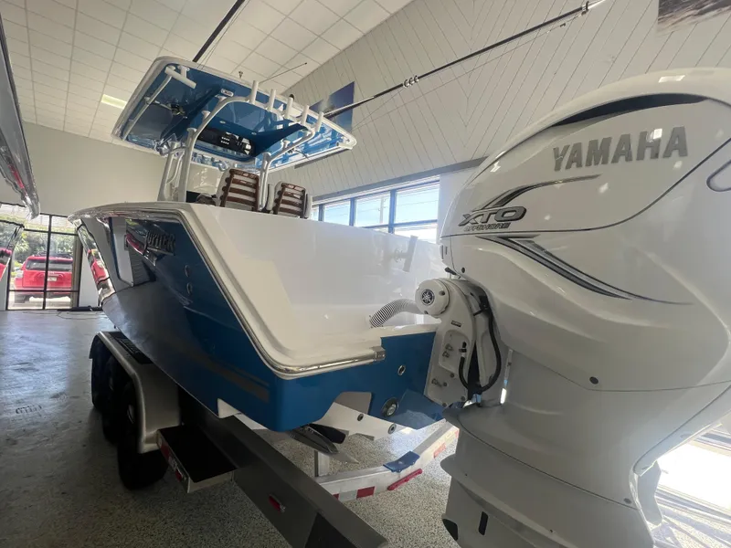 Slide: The Image of 2022 Jupiter 34 FS boat with Yamaha engine, displayed indoors on a trailer. - 11
