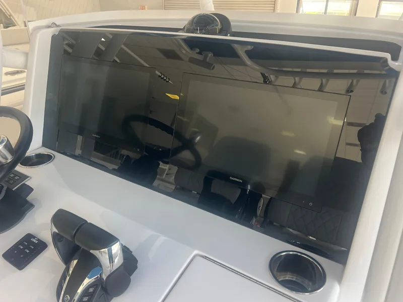 Slide: The Image of 2022 Jupiter 34 FS boat dashboard with dual screens and steering wheel. - 5