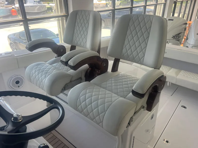 Slide: The Image of Luxury seating on 2022 Jupiter 34 FS boat with quilted upholstery and armrests. - 6