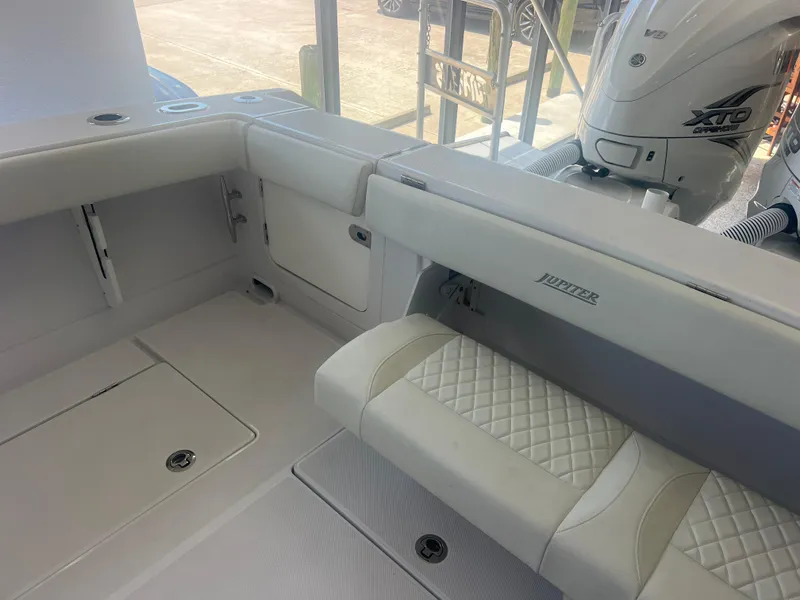 Slide: The Image of 2022 Jupiter 34 FS boat interior with cushioned seating and storage compartments. - 7