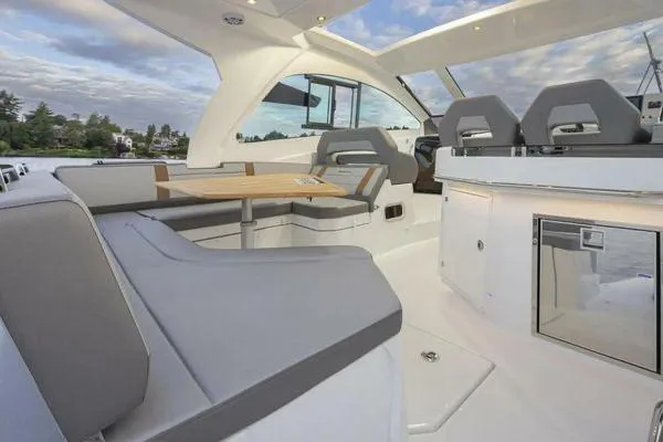 Slide: The Image of 2023 Beneteau GT32 yacht interior with modern seating and dining area. - 12
