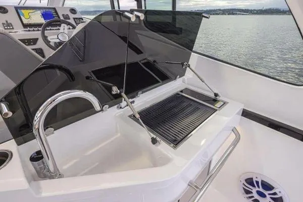 Slide: The Image of 2023 Beneteau GT32 yacht interior with sleek kitchen and modern amenities. - 15