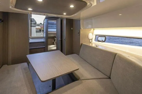 Slide: The Image of Interior of 2023 Beneteau GT32 yacht with modern seating and dining area. - 17