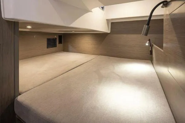 Slide: The Image of Interior cabin of 2023 Beneteau GT32 yacht, featuring cozy sleeping area with modern lighting. - 18