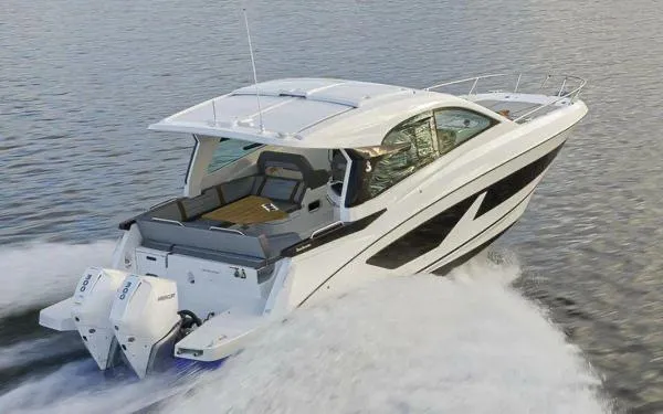 Slide: The Image of 2023 Beneteau GT32 cruising on water, showcasing sleek design and powerful outboard engines. - 2