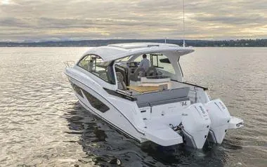 Slide: The Image of 2023 Beneteau GT32 boat cruising on calm waters under a cloudy sky. - 5