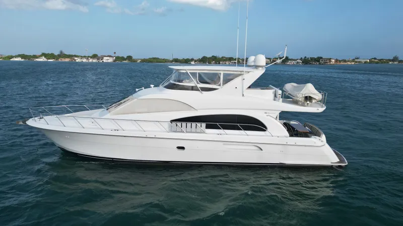 The Image of 2006 Hatteras 64 Motor Yacht cruising on open water, showcasing sleek design and powerful performance. - 0