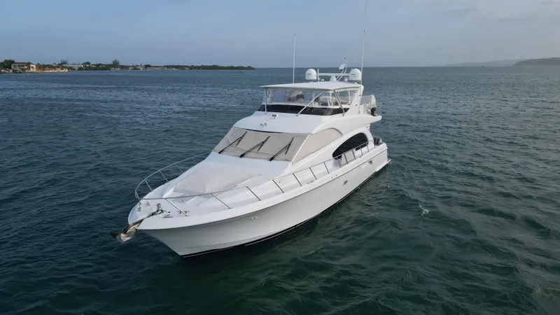 Slide: The Image of 2006 Hatteras 64 Motor Yacht cruising on open water. - 11