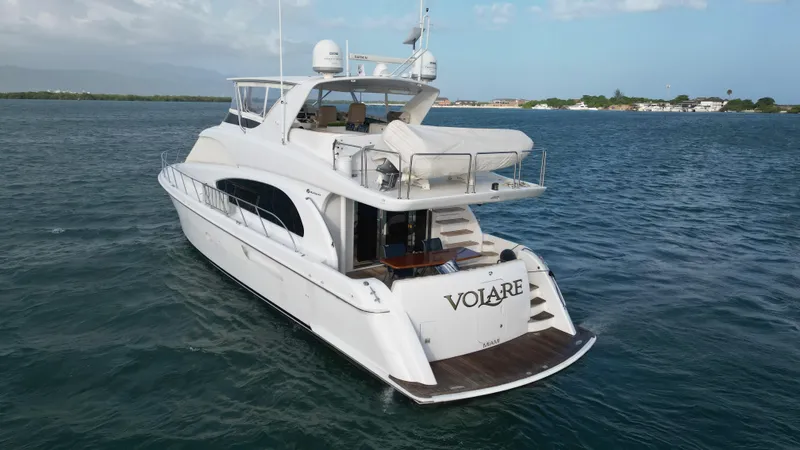 Slide: The Image of 2006 Hatteras 64 Motor Yacht on open water, rear view, clear sky. - 13
