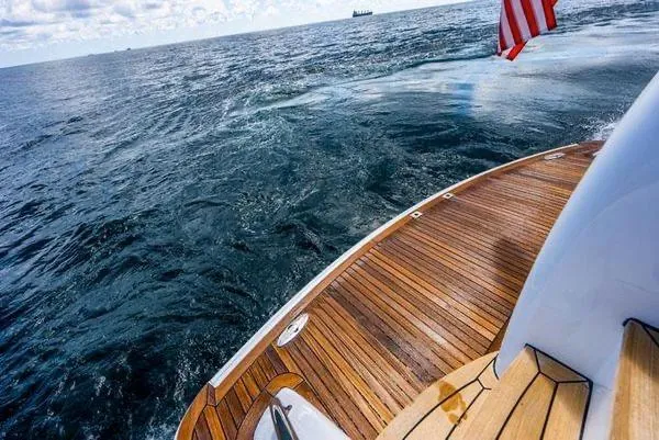 Slide: The Image of 2006 Hatteras 64 Motor Yacht deck with ocean view and American flag. - 16