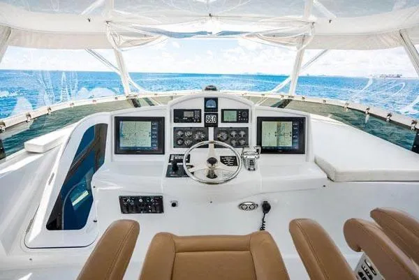 Slide: The Image of Helm of 2006 Hatteras 64 Motor Yacht with ocean view and navigation equipment. - 18