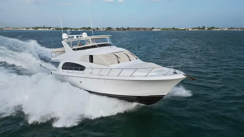 Slide: The Image of 2006 Hatteras 64 Motor Yacht cruising on open water. - 2