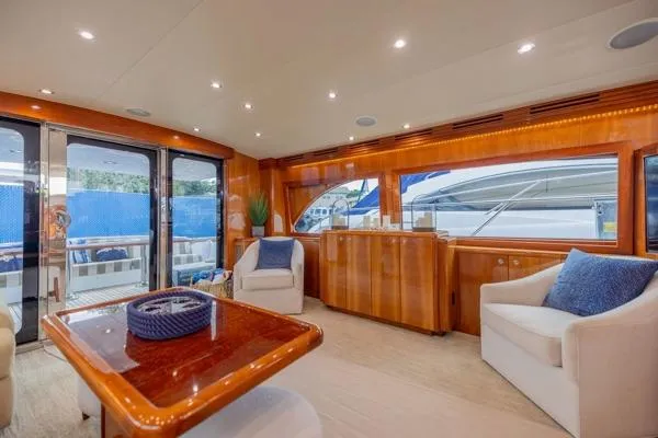Slide: The Image of Luxurious interior of 2006 Hatteras 64 Motor Yacht with elegant seating and wood finishes. - 21