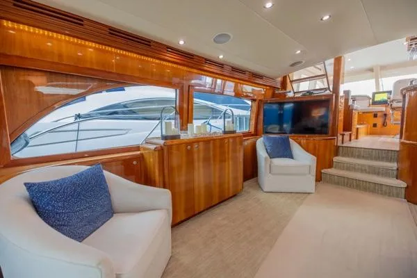Slide: The Image of Luxurious interior of 2006 Hatteras 64 Motor Yacht with plush seating and wood paneling. - 23