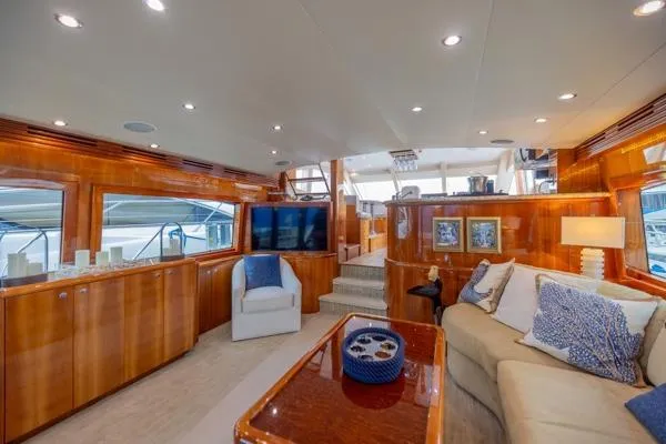 Slide: The Image of Luxurious interior of 2006 Hatteras 64 Motor Yacht with elegant wood finishes and plush seating. - 26