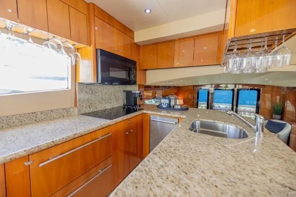 Slide: The Image of Luxurious kitchen interior of 2006 Hatteras 64 Motor Yacht with granite countertops and wood cabinetry. - 29