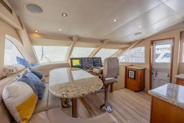 Slide: The Image of Luxurious interior of 2006 Hatteras 64 Motor Yacht with plush seating and navigation equipment. - 30