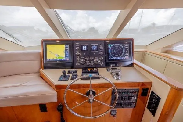 Slide: The Image of Helm of 2006 Hatteras 64 Motor Yacht with navigation screens and controls. - 34
