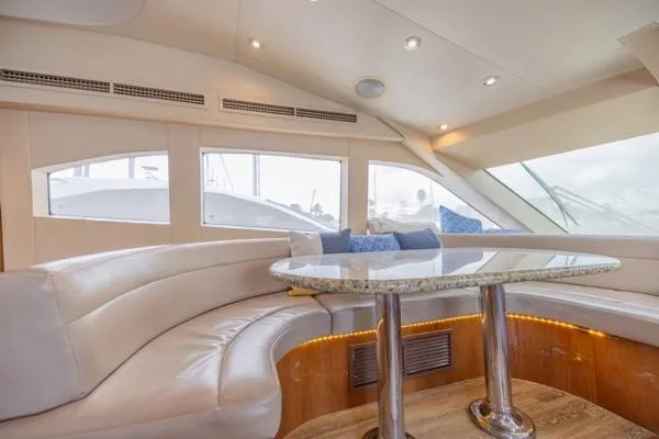 Slide: The Image of Luxurious interior of 2006 Hatteras 64 Motor Yacht with plush seating and elegant table. - 35