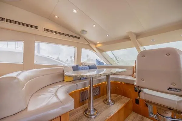Slide: The Image of Luxurious interior of 2006 Hatteras 64 Motor Yacht with plush seating and elegant table. - 36