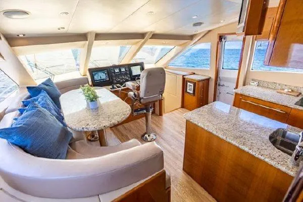 Slide: The Image of Luxurious interior of 2006 Hatteras 64 Motor Yacht with plush seating and modern helm. - 37