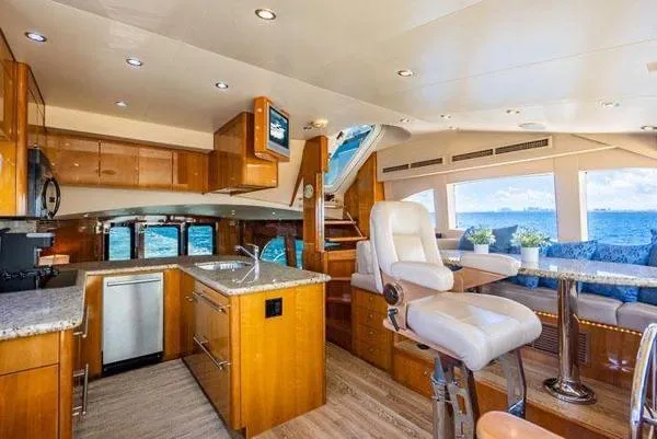 Slide: The Image of Luxurious interior of 2006 Hatteras 64 Motor Yacht with modern kitchen and ocean view. - 38