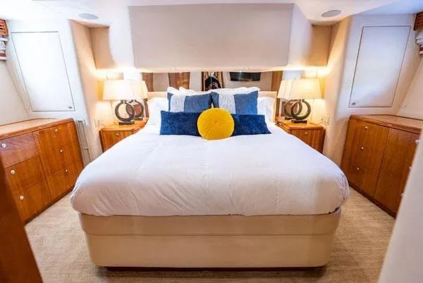 Slide: The Image of Luxurious bedroom interior of 2006 Hatteras 64 Motor Yacht with elegant bedding and wooden cabinetry. - 41
