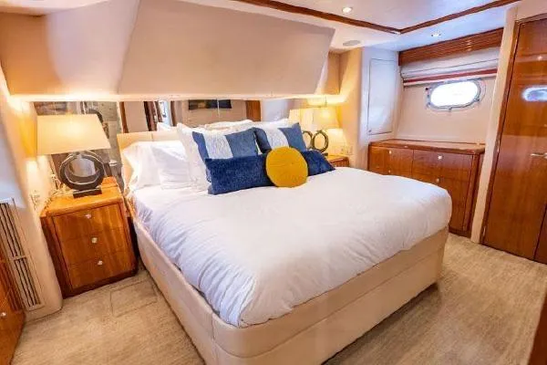 Slide: The Image of Luxurious bedroom interior of 2006 Hatteras 64 Motor Yacht with elegant furnishings. - 42
