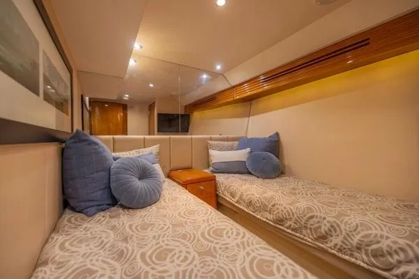 Slide: The Image of Luxurious cabin interior of 2006 Hatteras 64 Motor Yacht with twin beds and plush pillows. - 43