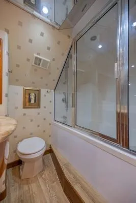 Slide: The Image of Bathroom interior of 2006 Hatteras 64 Motor Yacht with modern fixtures and large window. - 44