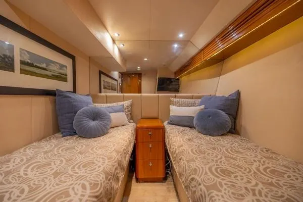 Slide: The Image of Luxurious twin cabin in 2006 Hatteras 64 Motor Yacht with elegant decor and plush bedding. - 46