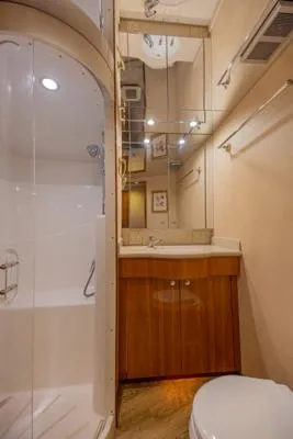 Slide: The Image of 2006 Hatteras 64 Motor Yacht bathroom with shower, vanity, and toilet. - 47